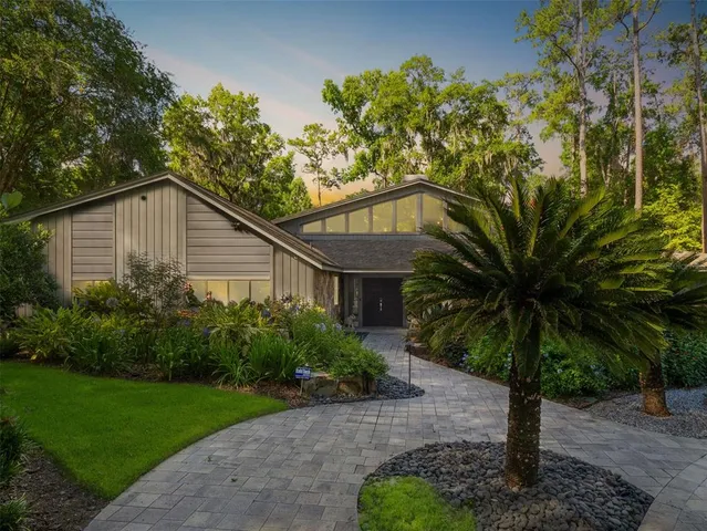 a house that has a tree in front of the house