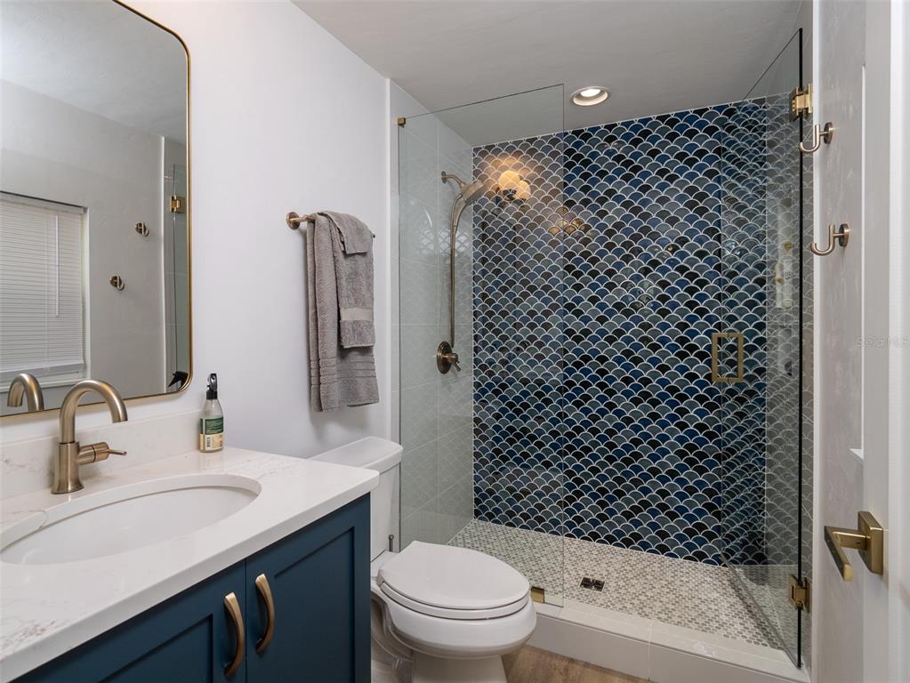 2416 Northwest 22 Drive Gainesville, FL 32605 - Photo 11 of 35 a bathroom with a sink toilet and shower