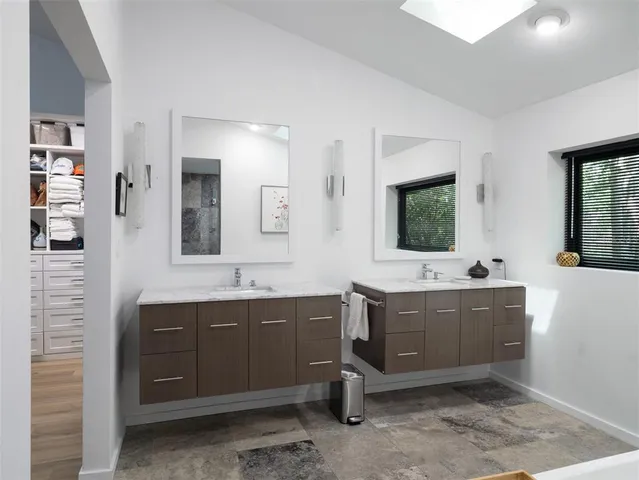 a spacious bathroom with a tub sink and mirror