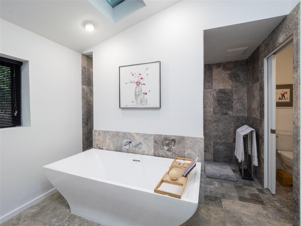 2416 Northwest 22 Drive Gainesville, FL 32605 - Photo 16 of 35 a bath tub sitting next to a bathroom