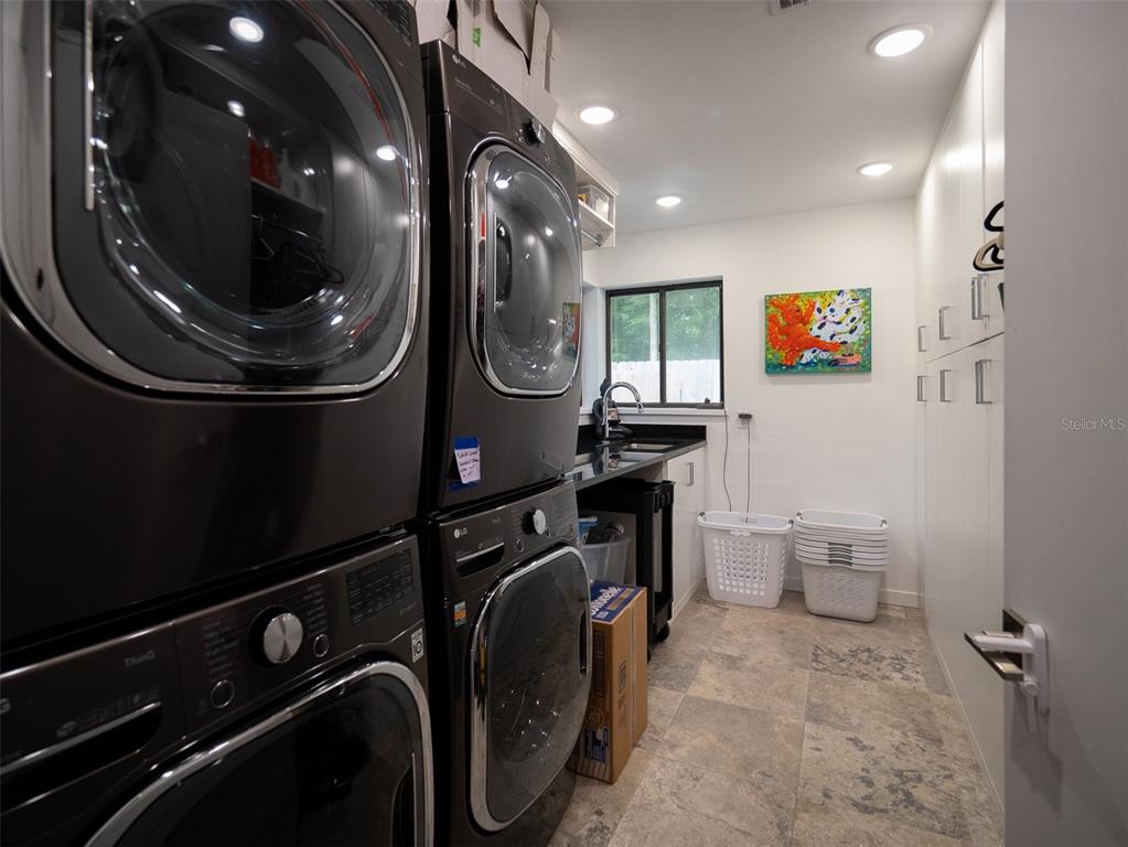 2416 Northwest 22 Drive Gainesville, FL 32605 - Photo 24 of 35 a view of a storage and utility room with a washer dryer
