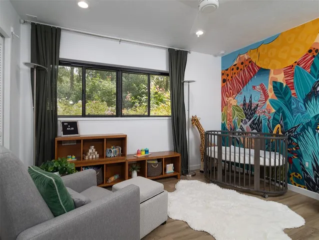 a living room with furniture and a floor to ceiling window