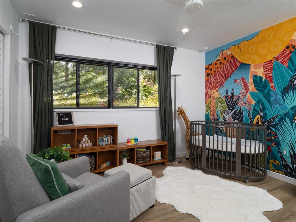 2416 Northwest 22 Drive Gainesville, FL 32605 - Photo 26 of 35 a living room with furniture and a floor to ceiling window