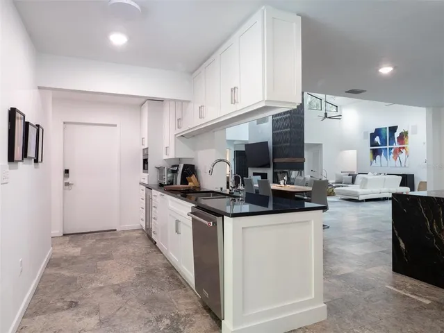 a kitchen with stainless steel appliances granite countertop a sink and cabinets