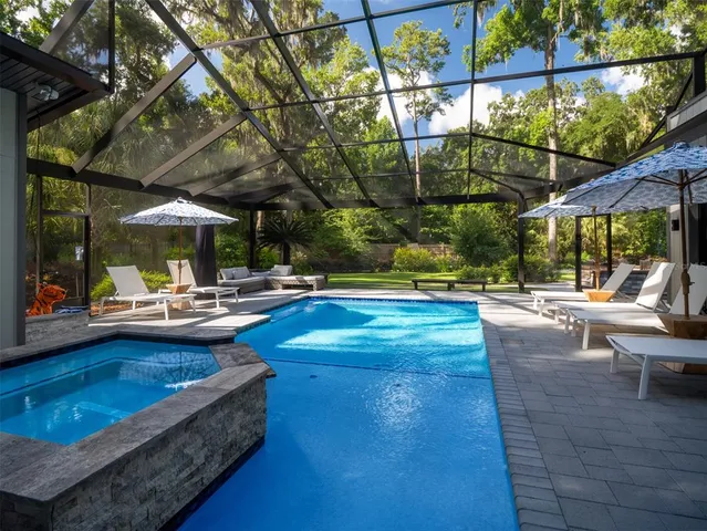 a swimming pool with outdoor seating and yard
