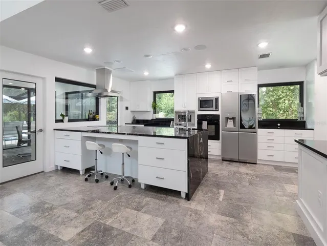 a kitchen with white cabinets and white appliances