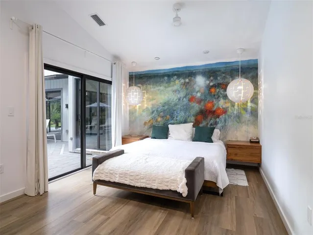 a bedroom with a bed and a large window