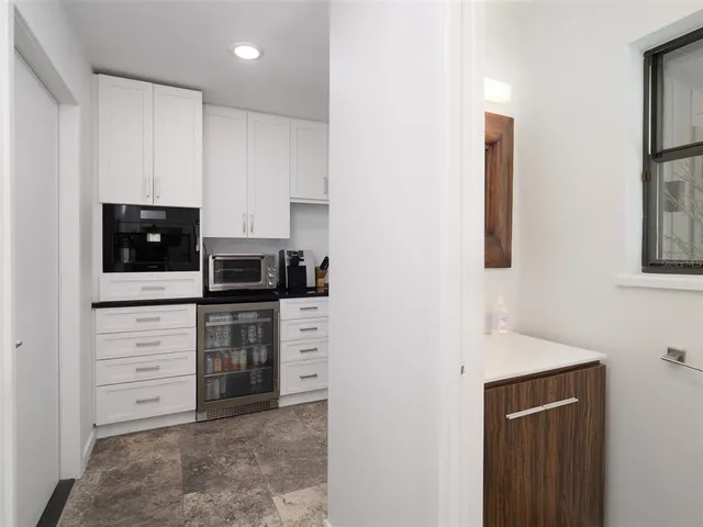 a kitchen with stainless steel appliances a stove and microwave