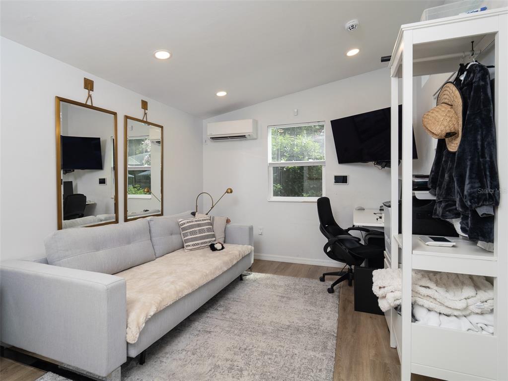 2416 Northwest 22 Drive Gainesville, FL 32605 - Photo 10 of 35 a living room with furniture and a flat screen tv