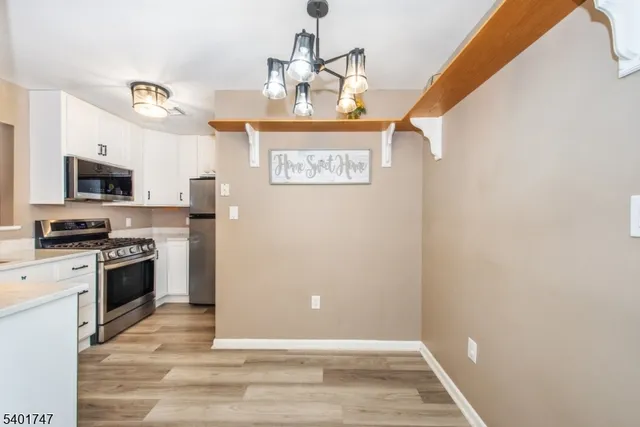 a view of kitchen with sink microwave and stove