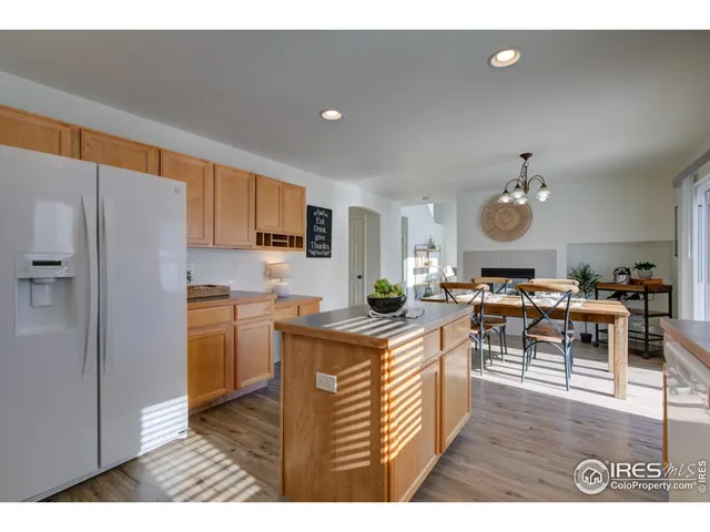 a kitchen with a sink cabinets and wooden floor