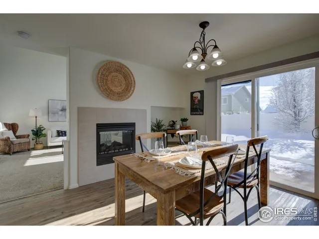 a view of a dining room with furniture and a chandelier