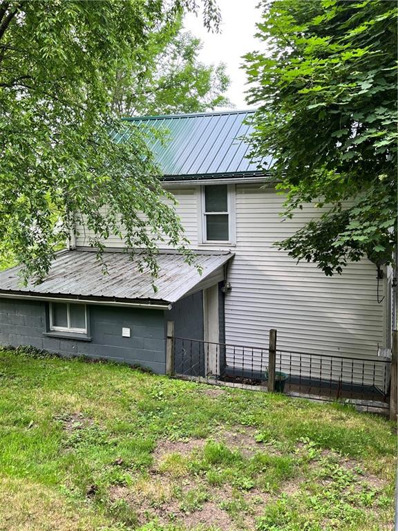 311 Lowell Street Vandergrift, PA 15690 - Photo 2 of 21 a view of a house with a backyard and a tree