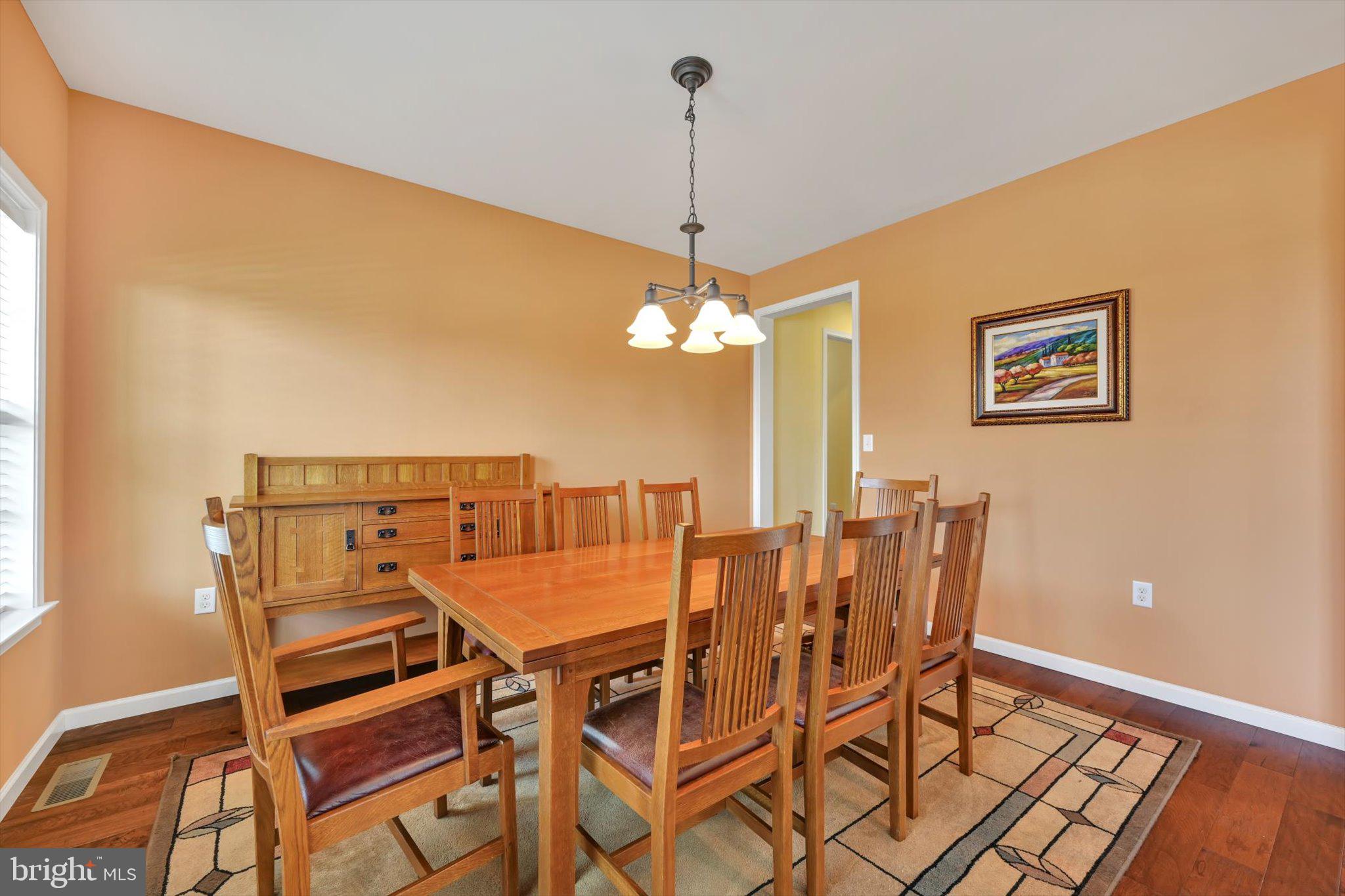 628 Warminster Lane Lititz, PA 17543 - Photo 10 of 50 a view of a dining room with furniture and wooden floor