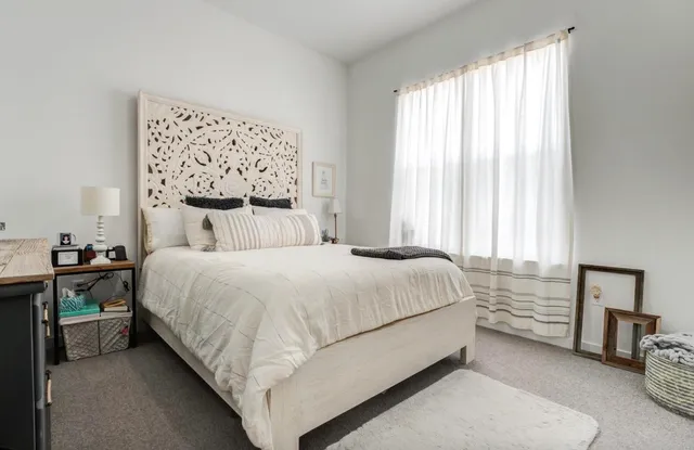 a bedroom with a bed and a window