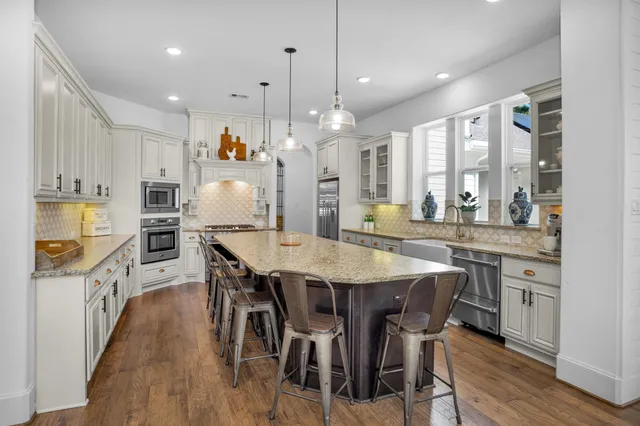 a large kitchen with a table and chairs
