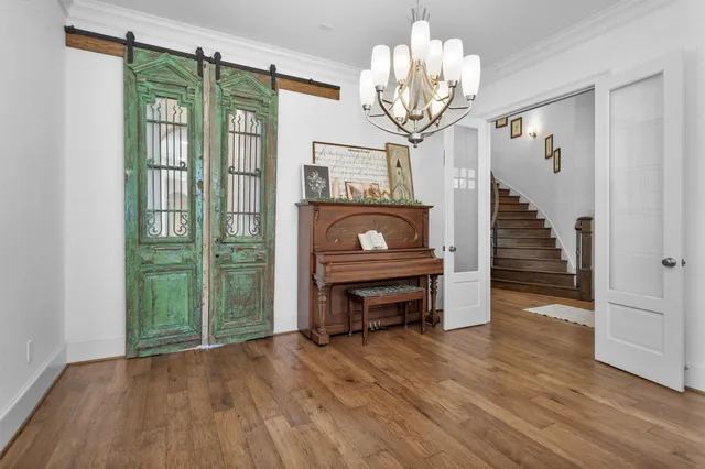 a view of a livingroom with wooden floor and furniture