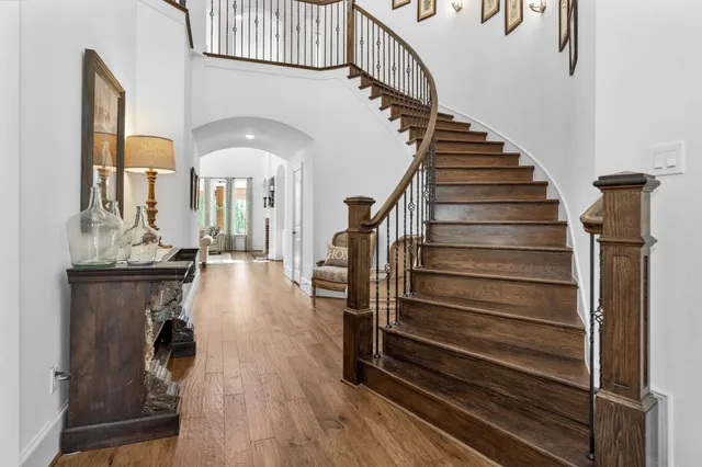 a view of entryway and hall with wooden floor