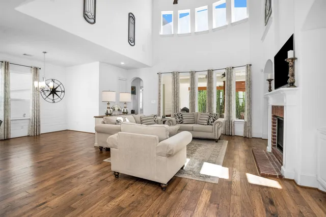 a living room with furniture fireplace and flat screen tv