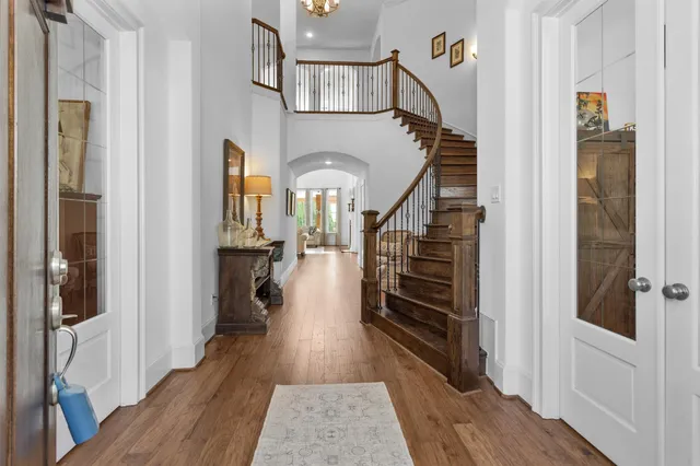 a view of a hallway view with wooden floor and staircase