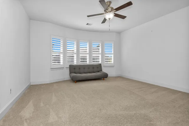 a room with a fan and a window