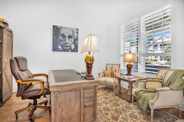 a work room with furniture and next to a window