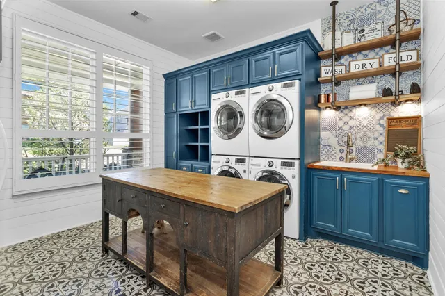 a bathroom with a granite countertop sink and a large mirror