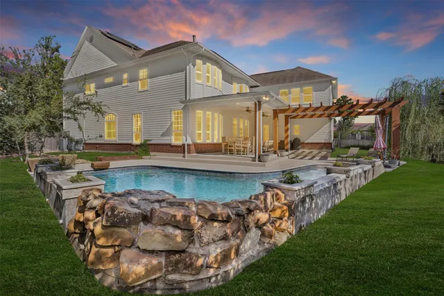 a view of a house with a big yard and potted plants