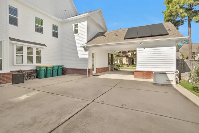an aerial view of a house with a yard potted plants and large tree