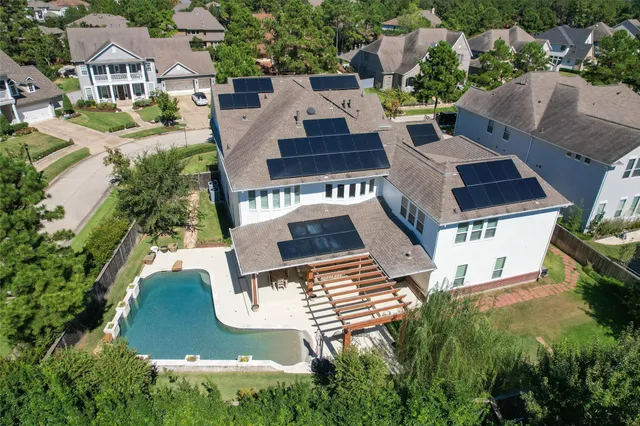 an aerial view of a house having yard and a patio