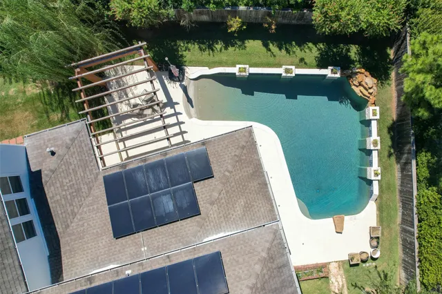 an aerial view of a house with a yard and potted plants