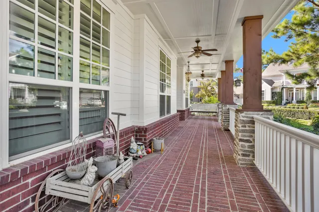 a balcony with wooden floor and outdoor seating