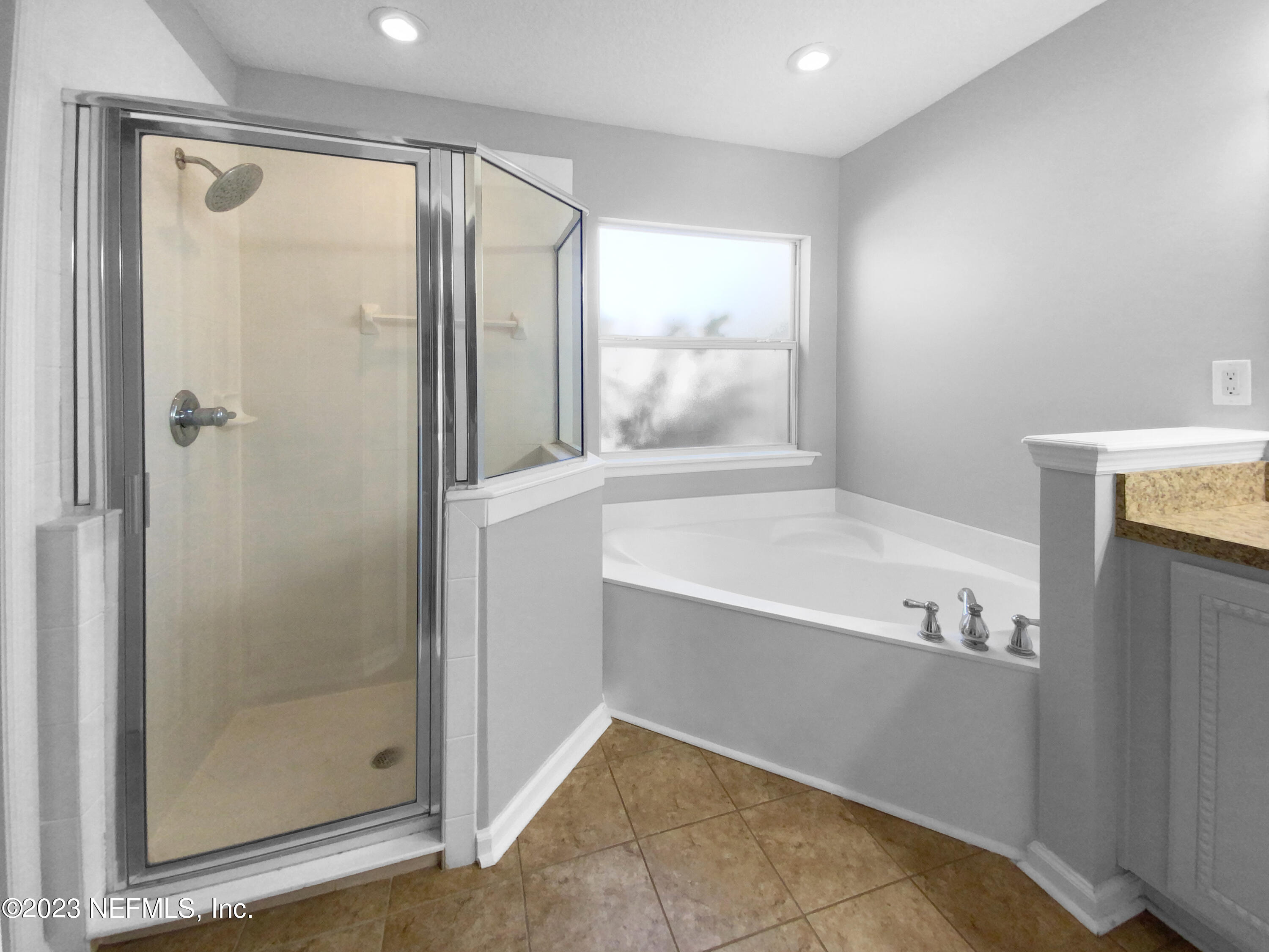 5783 Brush Hollow Road Jacksonville, FL 32258 - Photo 11 of 19 a bathroom with a bathtub and a shower