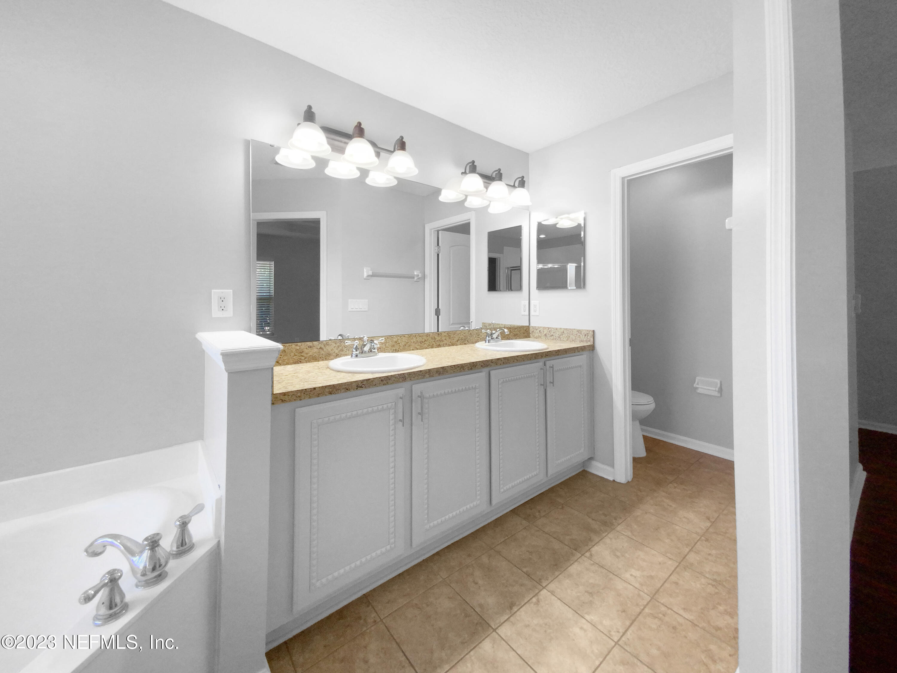 5783 Brush Hollow Road Jacksonville, FL 32258 - Photo 12 of 19 a bathroom with a sink and a mirror