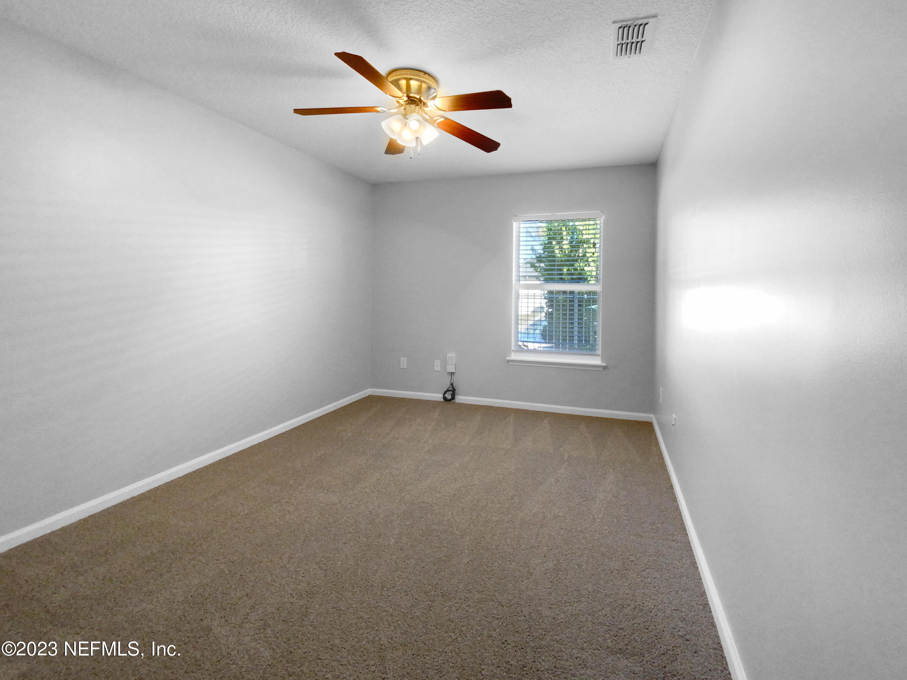5783 Brush Hollow Road Jacksonville, FL 32258 - Photo 14 of 19 an empty room with a window and a fan