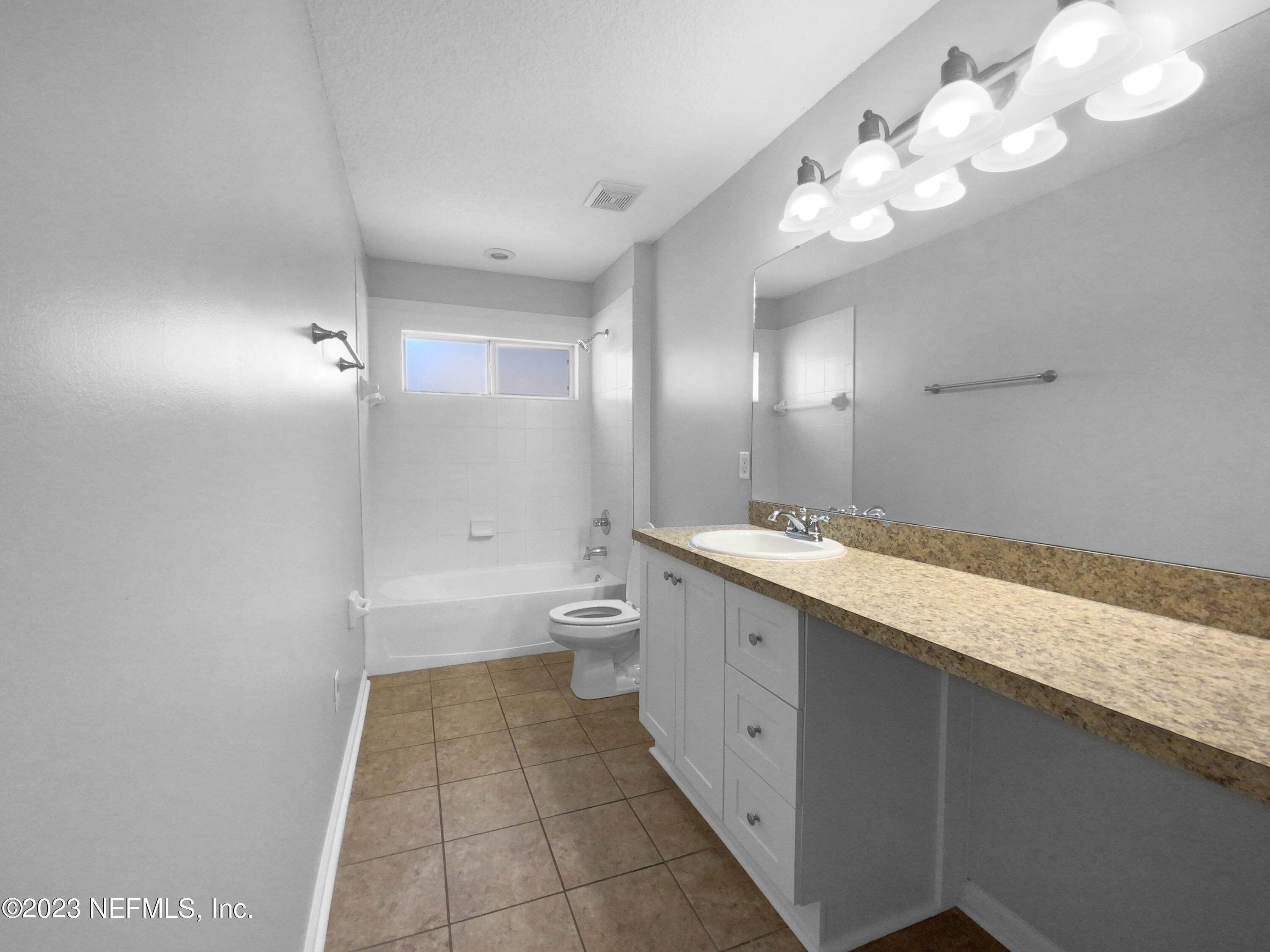 5783 Brush Hollow Road Jacksonville, FL 32258 - Photo 15 of 19 a spacious bathroom with a granite countertop sink a toilet and a large mirror