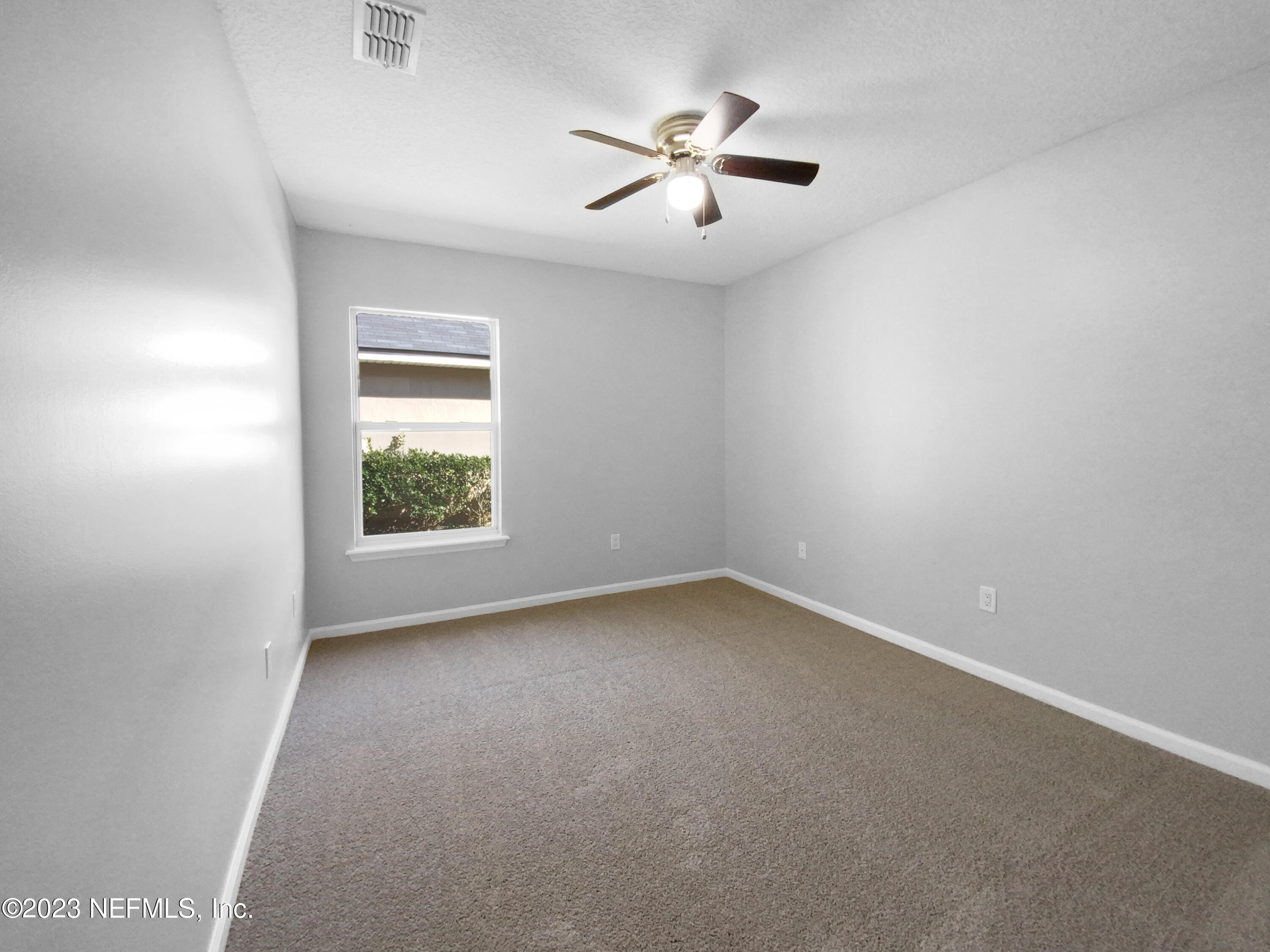 5783 Brush Hollow Road Jacksonville, FL 32258 - Photo 16 of 19 an empty room with a window and a fan
