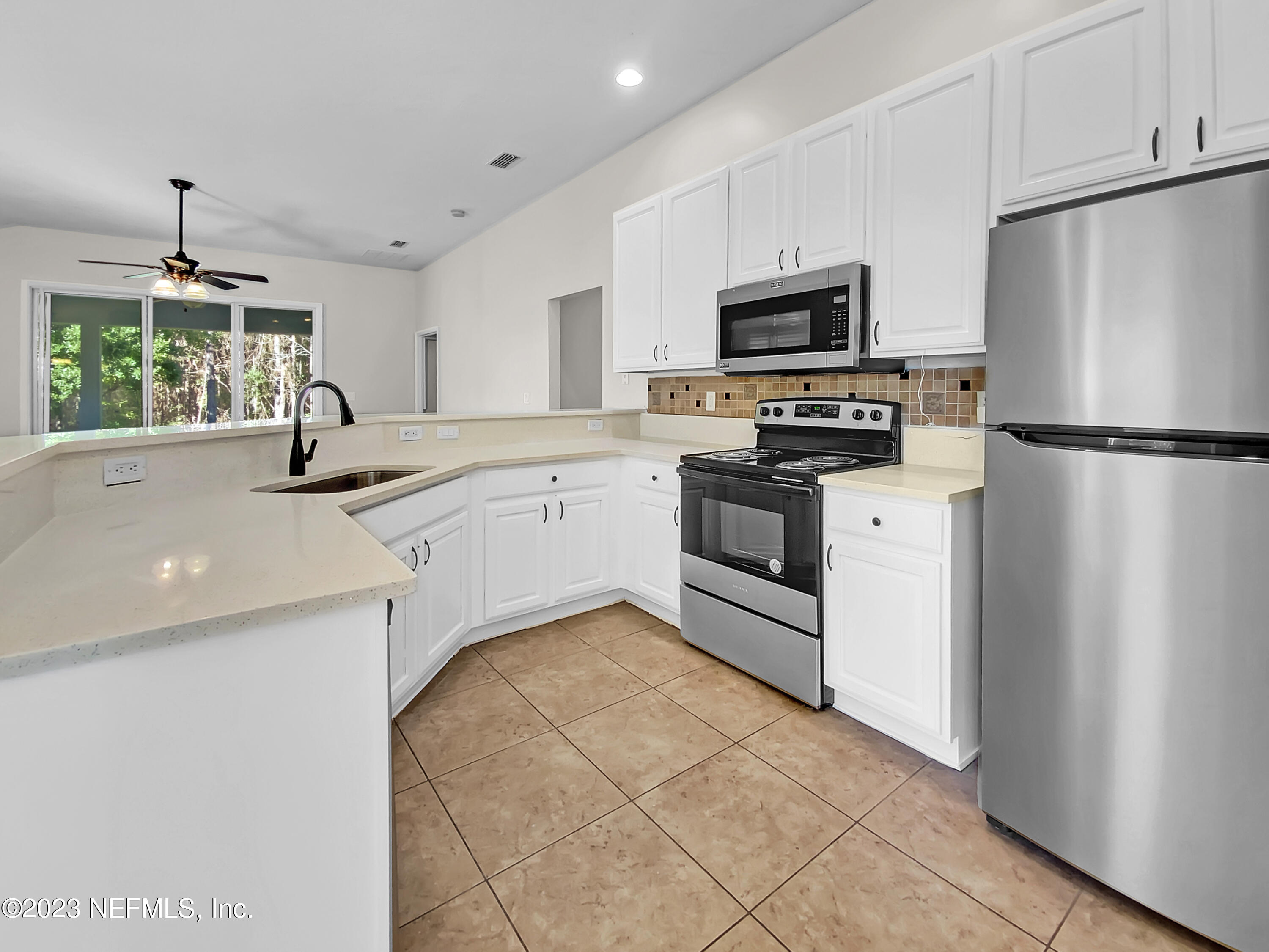 5783 Brush Hollow Road Jacksonville, FL 32258 - Photo 17 of 19 a kitchen with stainless steel appliances granite countertop a refrigerator sink and stove