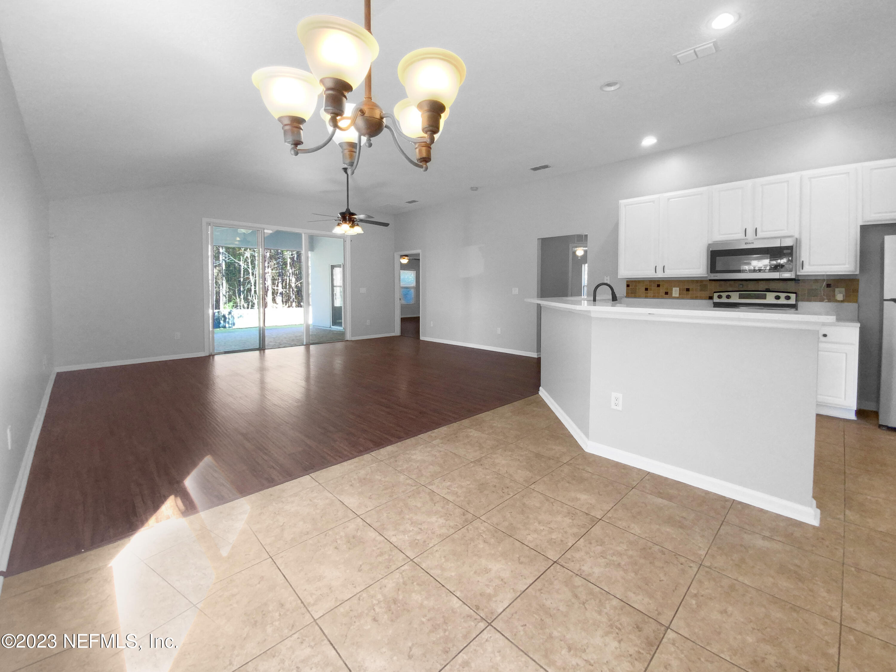 5783 Brush Hollow Road Jacksonville, FL 32258 - Photo 6 of 19 a view of a kitchen with a sink wooden cabinets and a chandelier