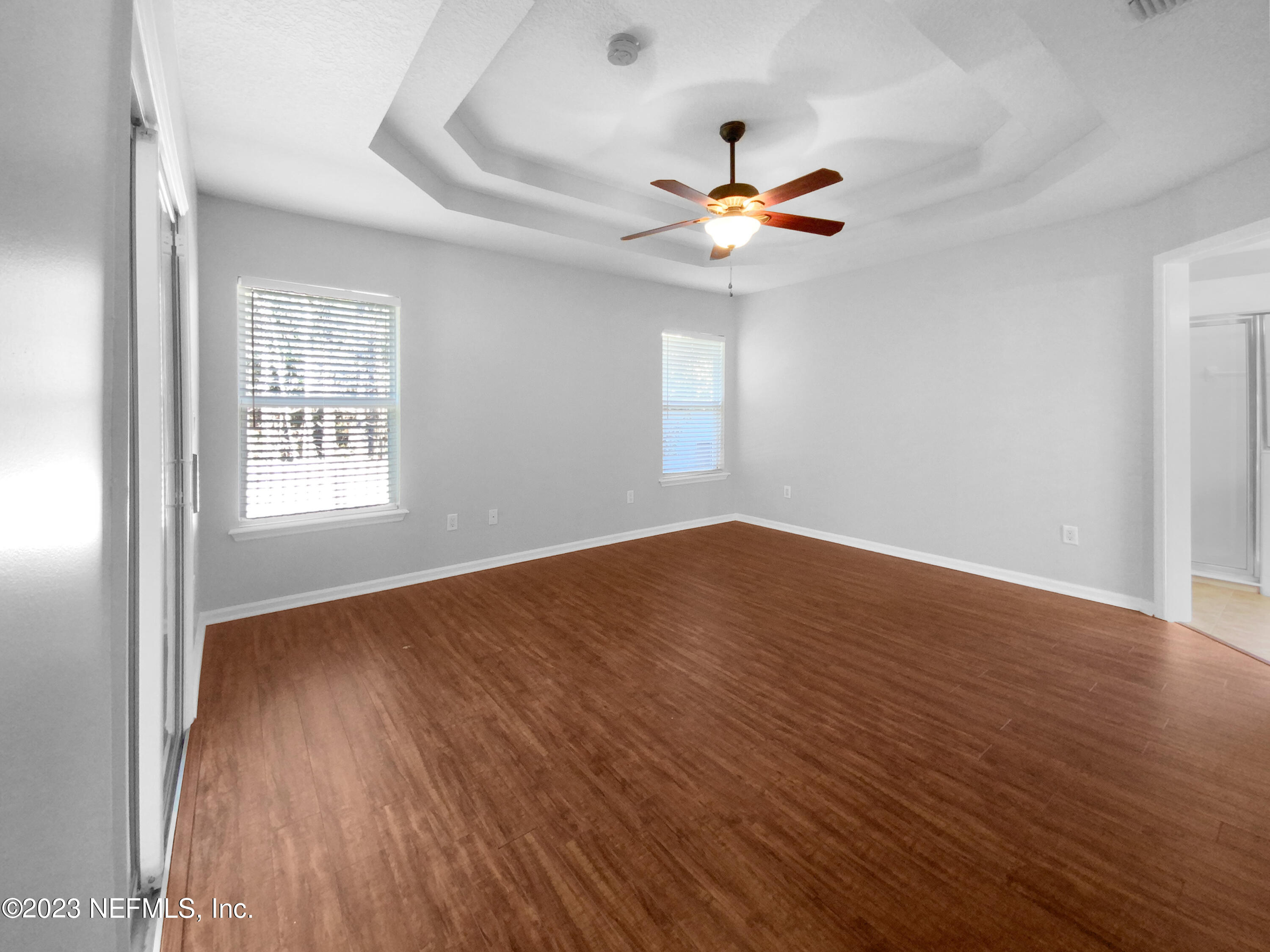 5783 Brush Hollow Road Jacksonville, FL 32258 - Photo 8 of 19 a view of an empty room with wooden floor and a window