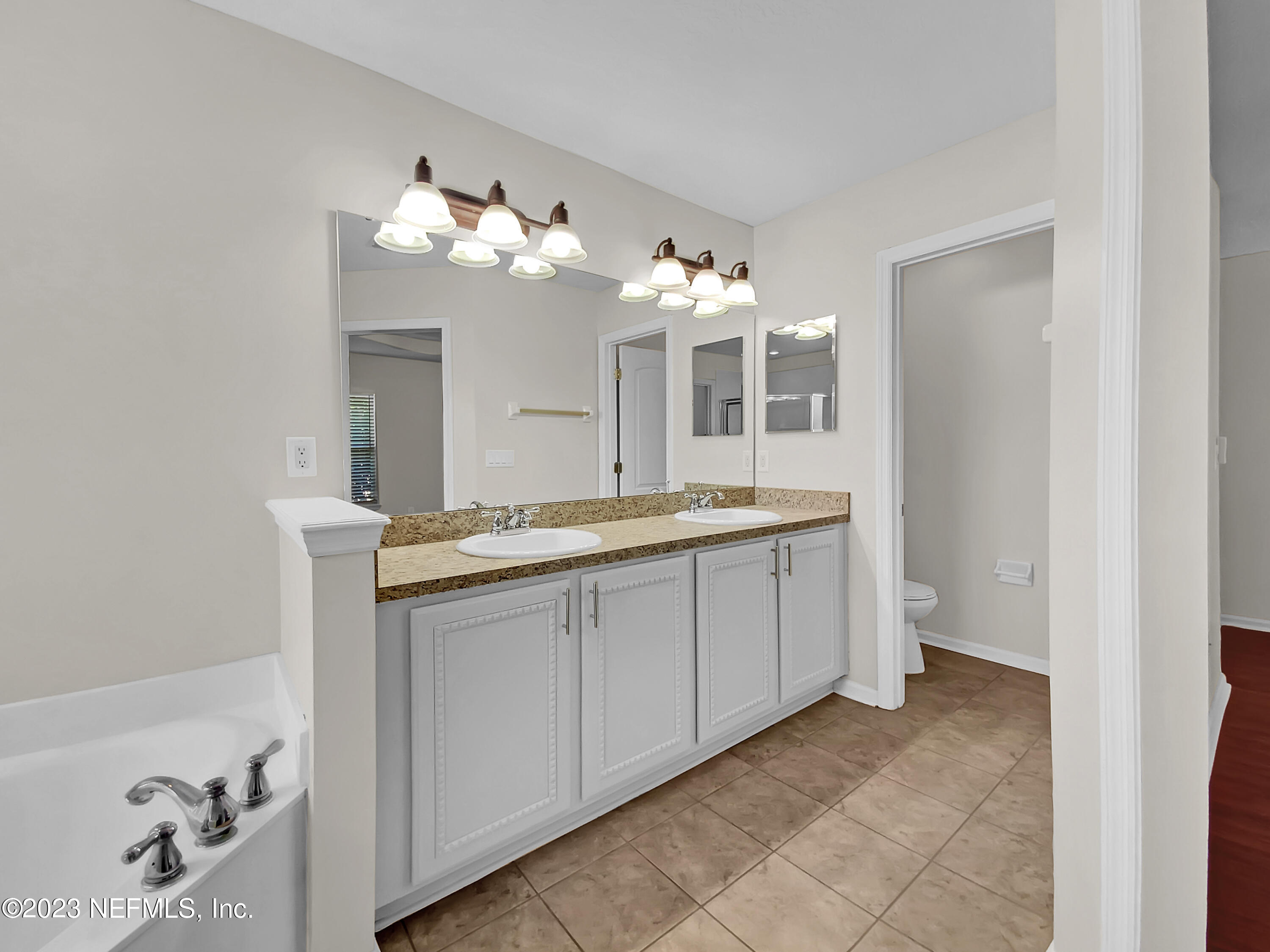 5783 Brush Hollow Road Jacksonville, FL 32258 - Photo 10 of 19 a bathroom with a sink and a mirror