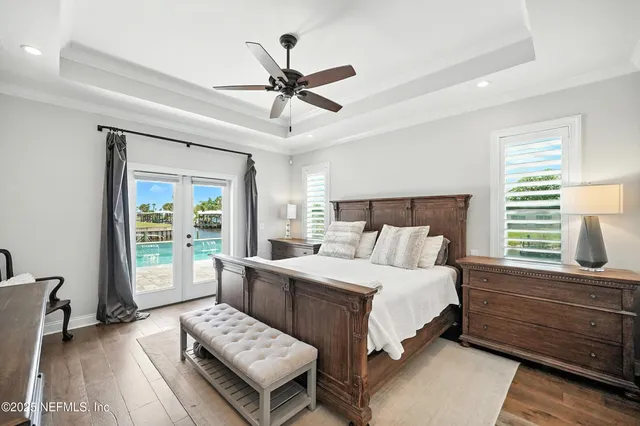 a bathroom with white cabinets a sink and a mirror