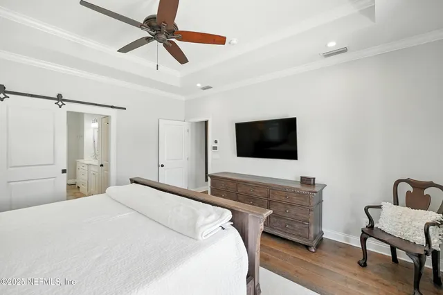 a view of hallway with stairs and wooden floor
