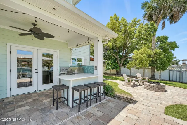 an aerial view of residential houses with outdoor space and trees