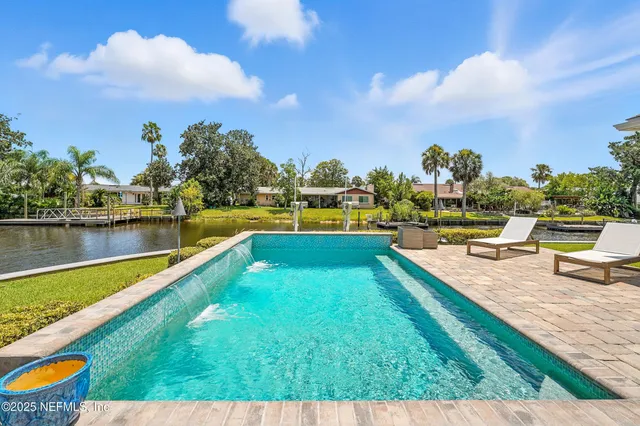 a view of a swimming pool with a table and chairs