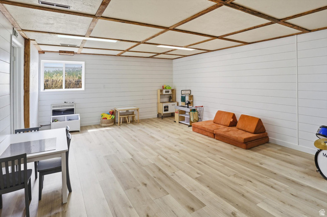 5108 South 2000th Street West Roy, UT 84067 - Photo 31 of 61 Rec room featuring light wood-type flooring and wooden walls