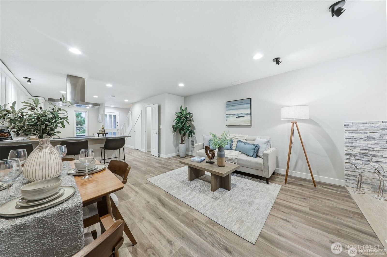 a living room with furniture and wooden floor