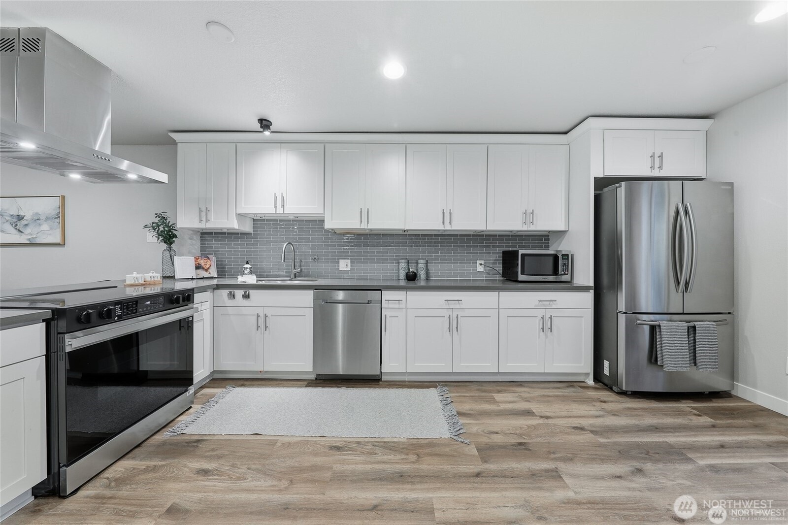 1940 North Northgate Way Seattle, WA 98133 - Photo 10 of 22 a kitchen with a refrigerator stove and white cabinets