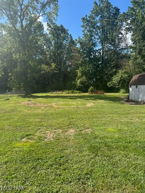 8136 Bellflower Road Mentor, OH 44060 - Photo 16 of 17 View of grassy yard featuring a storage unit