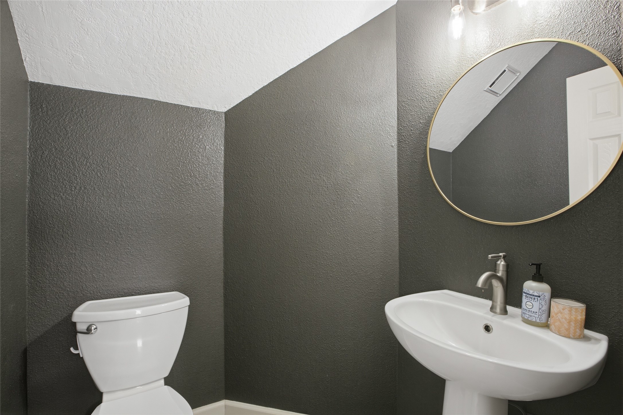 20907 Nettlebrook Lane Katy, TX 77450 - Photo 20 of 46 The half bath adds a thoughtful touch for guests, with a pedestal sink and custom mirror that give it a bit of personality.